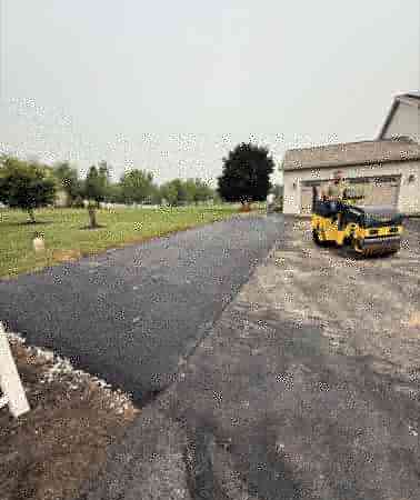 Roller finishing a residential driveway